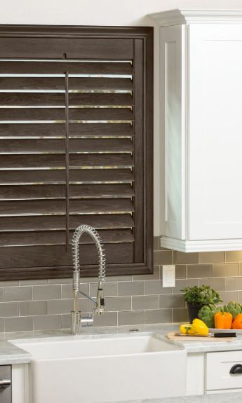 Modern sink with stylish shutters installed above it