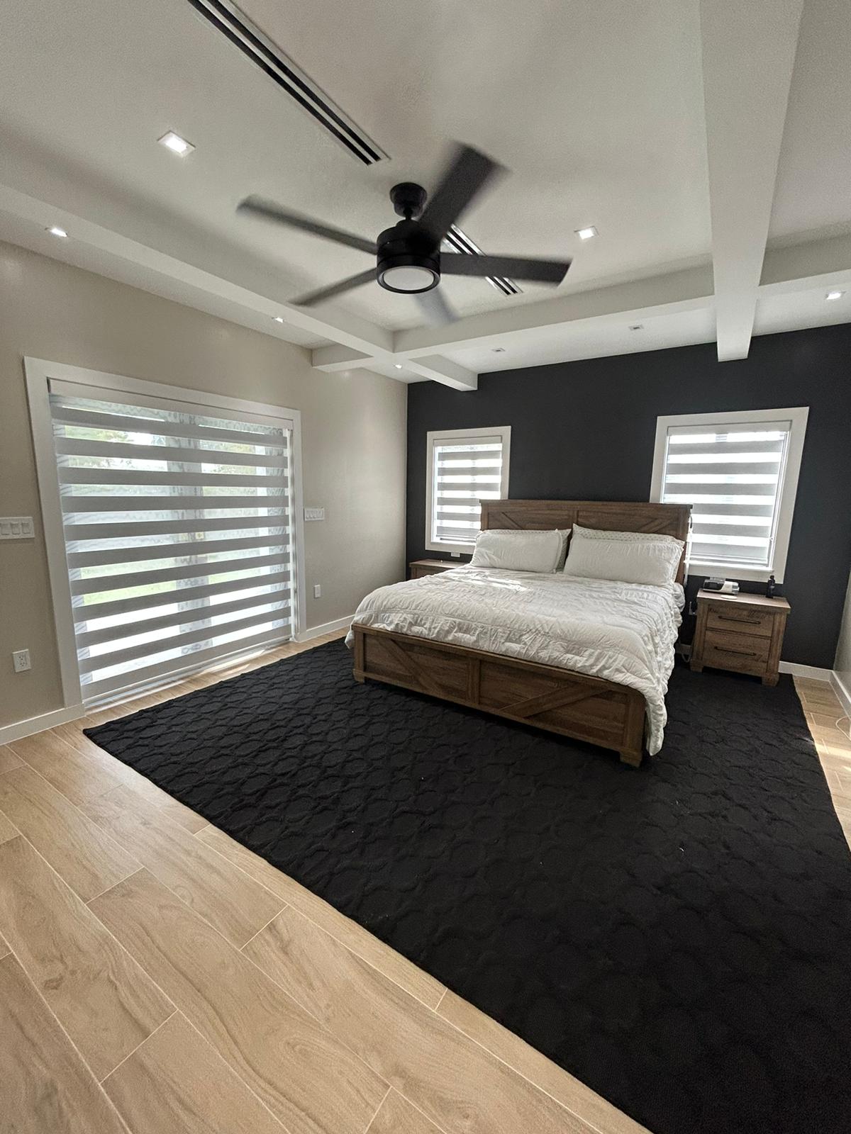 Spacious bedroom featuring a large ceiling fan for a comfortable and stylish living space