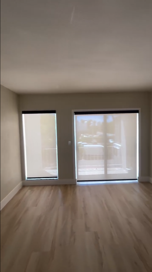 Living room featuring stylish window screens, adding elegance and functionality to the space.