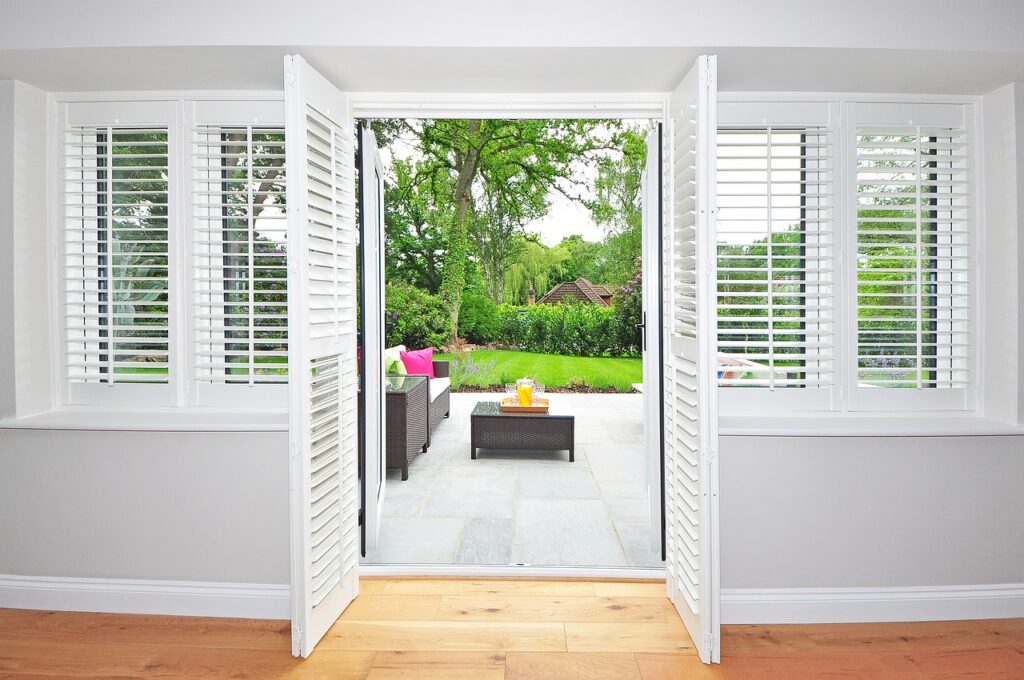 Elegant Miami window treatments featuring custom blinds and shades in a modern living room setting.